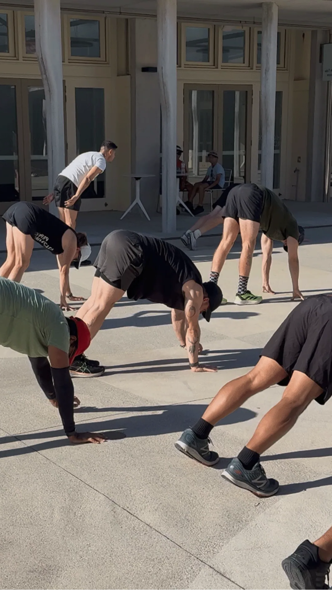 Athletes training mobility together outdoors